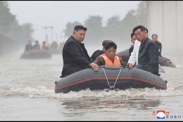 This recent undated photo released by North Korea's official Korean Central News Agency (KCNA) via KNS on July 31, 2024 shows North Korea's leader Kim Jong Un (L) riding in a dingy through flood waters as he inspects the area for damage after record-breaking heavy rains on July 29 in the city of Sinuiju in North Pyongan Province. (Photo by KCNA VIA KNS / AFP)